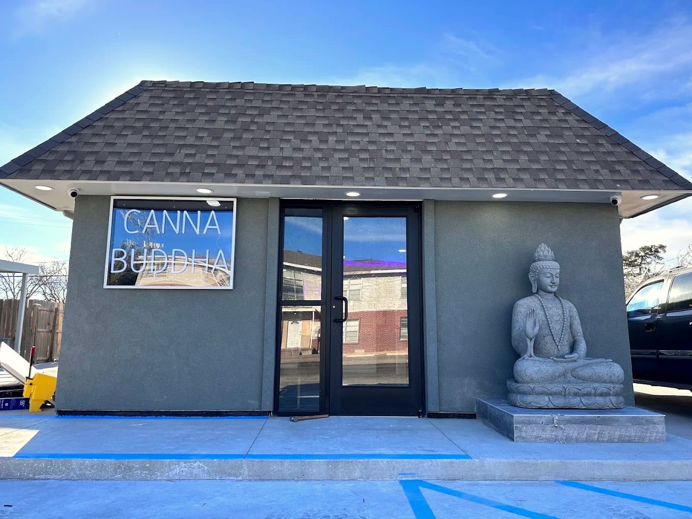 Canna Buddha Hobbs storefront with stone Buddha statue